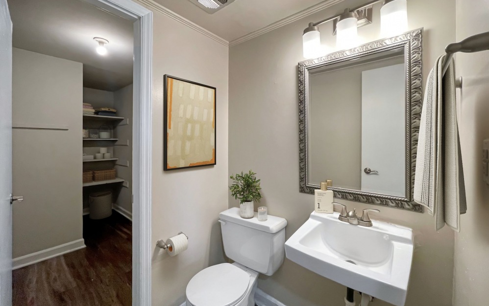 Townhome bathroom with sink, toilet, and walk-in closet